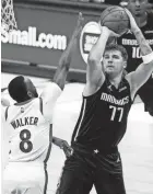  ?? KEVIN JAIRAJ/USA TODAY SPORTS ?? Mavericks guard Luka Doncic (77) shoots over Celtics guard Kemba Walker (8) during the second half at American Airlines Center on Tuesday.