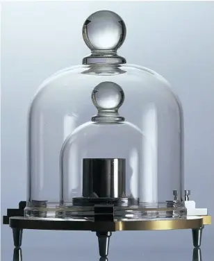  ??  ?? The original kilogram is kept under guard, and glass, in France, with descendant copies in various other parts of the world.