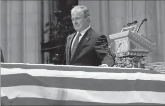  ?? AP PHOTO ?? Former President George W. Bush touches the casket of his father, former president George H.W. Bush, at the state funeral at the National Cathedral, Wednesday in Washington.