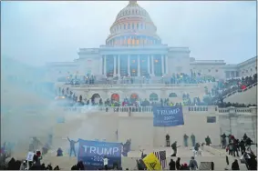  ?? LEAH MILLIS/REUTERS ?? Police officers stand guard as supporters of Donald Trump gather Jan. 6 in front of the Capitol Building in Washington.