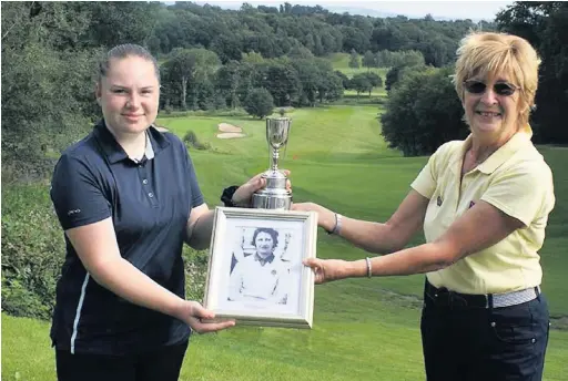  ??  ?? ●● Abigail McCoy presented with the trophy by Frances Gell