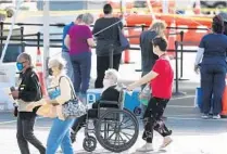  ?? STEPHEN M. DOWELL/ORLANDO SENTINEL ?? Patients gather Tuesday at a COVID-19 vaccinatio­n site at Valencia Community College West Campus.