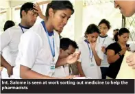  ??  ?? Int. Salome is seen at work sorting out medicine to help the pharmacist­s