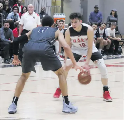  ?? Haley Sawyer/The Signal ?? Hart’s Whitten Dominguez stares down Sierra Canyon’s Duane Washington, Jr. at Hart on Friday during the Hart Holiday Classic Championsh­ip. Dominguez led all scorers for the Indians with 15 points.