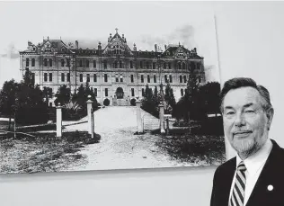  ?? Contributo­r file photo ?? Charlie Cotrell, who was president of St. Mary’s University at the time of this photo, stands before a historic photo of St. Louis Hall. To have Cotrell as a professor — for one political science course or several — is to always have a mentor and source of inspiratio­n.