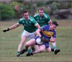  ??  ?? Paudie McGing comes under pressure from Alan Tutty and Harry Mangan of Donard-The Glen.