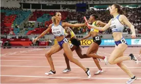  ??  ?? Laviai Nielsen takes the baton from Emily Diamond in the 4x400m final in which Great Britain finished fourth. Photograph: Patrick Smith/Getty Images