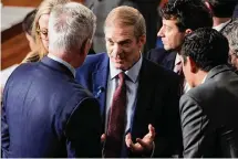  ?? Alex Brandon/Associated Press ?? Rep. Jim Jordan, R-Ohio, center, talks with Rep. Kevin McCarthy, R-Calif., left, and others as Republican­s try to elect Jordan to be the new House speaker Wednesday at the Capitol.