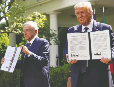  ?? KEVIN LAMARQUE/REUTERS ?? U.S. President Donald Trump holds a joint declaratio­n of solidarity he signed with Mexico’s President Andrés Manuel López Obrador in Washington on Wednesday. Prime Minister Justin Trudeau declined to attend amid the threat of U.S. tariffs against Canadian aluminum.