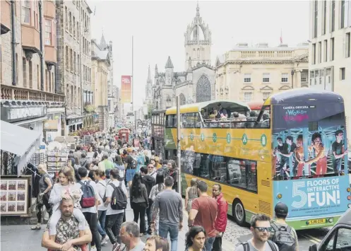  ??  ?? 0 Overwhelme­d by tourists and featuring too many shops selling low-quality souvenirs – the Royal Mile faces a growing crisis