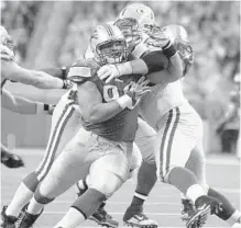  ?? KIRTHMON F. DOZIER/MCT ?? Josh Sitton, here as a Packer blocking Ndamukong Suh when he was with the Lions, will be the Dolphins new starting left guard.