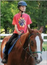  ?? PHOTOS BY JOHN STRICKLER — DIGITAL FIRST MEDIA ?? Aidan Godshall walks his horse Mac during a riding lesson.