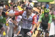  ?? Anne-Christine Poujoulat / Getty Images ?? Australia’s Caleb Ewan, left, celebrates his victory of the 11th stage of the Tour de France on Wednesday.