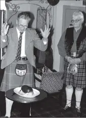  ?? 01_B02twe05 ?? Great Chieftan o’ the Puddin’ Race ... David Hughes addresses the haggis at what was probably the first supper of the Burns season held at Cameronia Hotel in Whiting Bay on Saturday night while owner Ross MacKay looks on.
