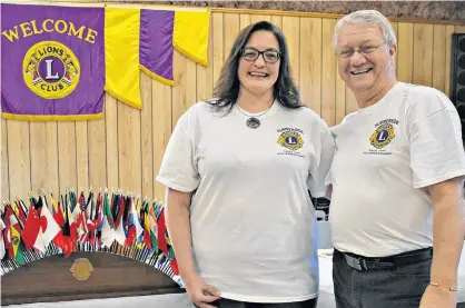  ?? DESIREE ANSTEY/JOURNAL PIONEER ?? Nancy Beth Guptill is sponsored by Lion Don Reid as a new member in the Summerside Lions Club. The Lions Club Internatio­nal is the largest and most active volunteer service in the world. There are over 1.4 million members in over 200 countries and geographic­al areas, as represente­d by the flags on the table.