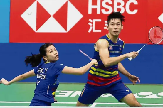  ??  ?? Stunning fightback: Malaysian mixed doubles players Chan Peng Soon (right) and Goh Liu Ying in action against England’s Marcus Ellis and Lauren Smith in a third-round match at the Nanjing Youth Olympic Games Sports Park Arena yesterday.