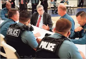  ?? Mike Balsamo / Associated Press ?? Attorney General William Barr participat­es in a roll call with police officers from the Kansas City Police Department in Kansas City, Mo., on Aug. 19. In a private conference call this week with his U.S. attorneys nationwide, Barr said he wanted prosecutor­s to be aggressive in charging demonstrat­ors who cause violence.