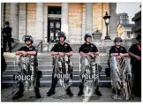  ?? JIM NOELKER /
STAFF ?? Dayton police at Courthouse Square, just before 7 p.m. on Sunday, May 31, toward the end of a weekend full of protests.