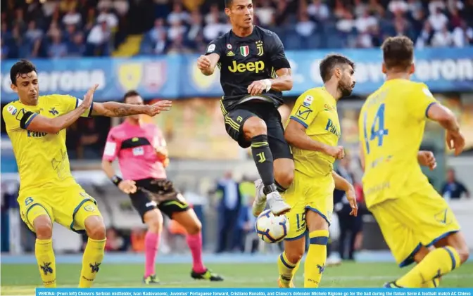  ?? — AFP ?? VERONA: (From left) Chievo’s Serbian midfielder, Ivan Radovanovi­c, Juventus’ Portuguese forward, Cristiano Ronaldo, and Chievo’s defender Michele Rigione go for the ball during the Italian Serie A football match AC Chievo vs Juventus yesterday.