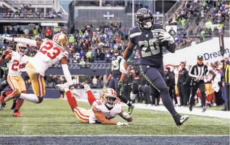  ?? Abbie Parr / Getty Images ?? Rashaad Penny of the Seahawks avoids a tackle by the 49ers’ Antone Exum for a 20-yard touchdown in the third quarter.