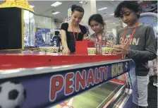  ??  ?? From left to right, Jana Arafa, Noor Mohammed and Maya Mohammed play games after the iftar for orphans and underprivi­leged children hosted by Ibn Battuta Mall