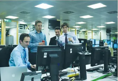  ?? (Clodagh Kilcoyne/Reuters) ?? ETX CAPITAL traders react as they watch the results of Britain’s election last Friday in London.