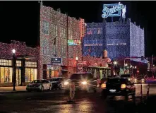  ?? [PHOTO BY DOUG HOKE, THE OKLAHOMAN] ?? Historic buildings all along Automobile Alley are draped in holiday colors as part of the annual Lights on Broadway that starts this weekend.