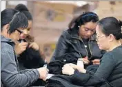  ?? Mark Boster
Los Angeles Times ?? WORKERS inspect merchandis­e at American Apparel’s sewing facilities in downtown Los Angeles.