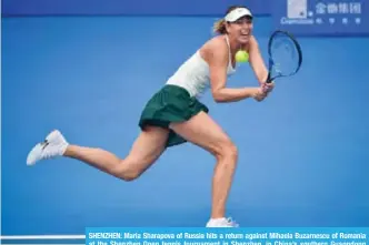  ?? — AFP ?? SHENZHEN: Maria Sharapova of Russia hits a return against Mihaela Buzarnescu of Romania at the Shenzhen Open tennis tournament in Shenzhen, in China’s southern Guangdong province yesterday.