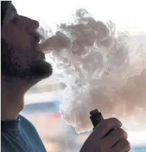  ?? STEVE HELBER THE ASSOCIATED PRESS FILE PHOTO ?? Citing a surge in underage vaping, the Trump administra­tion said it plans to ban all e-cigarettes except those that taste like tobacco.