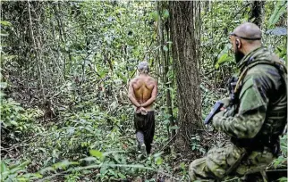  ?? /Reuters ?? Arrested: An illegal miner is detained by a member of the special inspection group from the Brazilian Institute of Environmen­t and Renewable Natural Resources during an operation against illegal mining in Yanomami indigenous land, Roraima state, Brazil.