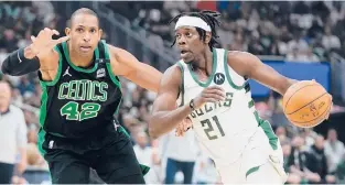  ?? ?? The Bucks’ Jrue Holiday drives past the Celtics’ Al Horford the first half of Game 4 on Monday in Milwaukee. MORRY GASH/AP