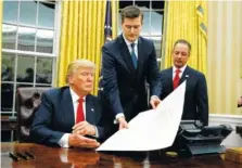  ?? ASSOCIATED PRESS FILE PHOTO ?? Former White House staff secretary Rob Porter, center, hands President Donald Trump a confirmati­on order for James Mattis as defense secretary in 2017. Porter resigned after allegation­s of abuse of his ex-wives became public.