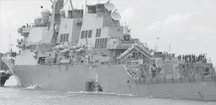  ?? ASSOCIATED PRESS ?? The guided-missile destroyer USS John S. McCain (DDG 56) steers towards the Changi Naval Base, Singapore.