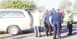  ??  ?? National Handling Services workers during the parade as they put the coffin in a hearse at Victoria Falls Internatio­nal Airport yesterday