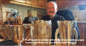  ?? Pat Fitzpatric­k at home with the the Allianz Hurling League trophy, Liam McCarthy Cup, and the Irish Press Cup. ??