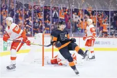  ?? MATT SLOCUM/ASSOCIATED PRESS ?? Philadelph­ia’s Travis Konecny (11) celebrates after scoring in overtime of the Flyers’ 6-5 win over visiting Detroit on Saturday afternoon.