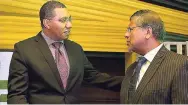  ??  ?? Prime Minister Andrew Holness (left) converses with British High Commission­er to Jamaica Asif Ahmad during Wednesday’s official opening of the Jamaica Special Economic Zone Authority at Waterloo Road, St Andrew.