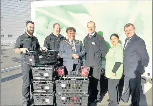  ??  ?? IT ASDA THE FUTURE: Staff outside the new home delivery centre in Cranford with Hounslow mayor Nisar Malik (third from left) and Nigel Yates from Hounslow Jobcentre (far right) – Asda has announced that robots will sort people’s shopping