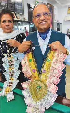  ?? Pankaj Sharma/Gulf News ?? Ram Tolani and his wife Seema with Indian currency garlands at the Goodwill Gallery at Business Bay in Dubai.