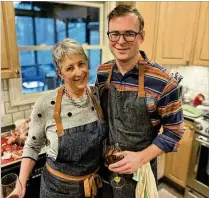  ?? COURTESY OF HENRI HOLLIS ?? AJC reporter/dining critic Henri Hollis and his mother, Harriett Hollis, wear matching aprons for Thanksgivi­ng 2021.