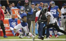  ?? SETH WENIG — THE ASSOCIATED PRESS ?? New York Giants wide receiver Odell Beckham (13) runs away from Baltimore Ravens’ Will Davis (31) for a touchdown during the second half of an NFL football game Sunday, Oct. 16, 2016, in East Rutherford, N.J.