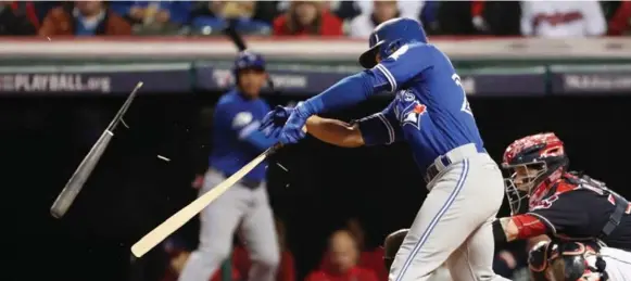  ?? RICHARD LAUTENS/TORONTO STAR ?? Jays second baseman Devon Travis breaks his bat during the fourth inning in Cleveland on Friday. Travis exited in the next inning after appearing to tweak his previously injured right knee.