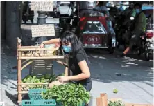  ??  ?? Selfless
initiative: Non refilling the Maginhawa Community pantry which she set up to help people who are badly affected by the pandemic. — philippine daily inquirer/aNN