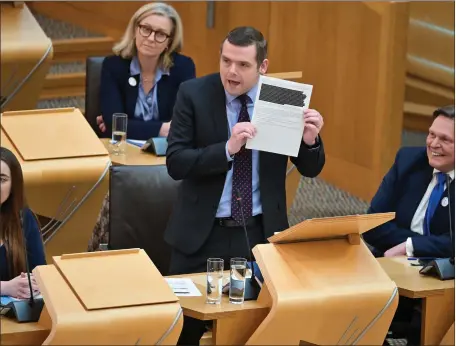  ?? ?? Scottish Conservati­ve leader Douglas Ross challenges Nicola Sturgeon over the ferry scandal at First Minister’s Questions