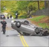  ?? PETE BANNAN – DIGITAL FIRST MEDIA ?? Radnor police investigat­e an overturned car after a crash on Newtown Road Friday afternoon. Police believe the car may be connected to an earlier store theft.
