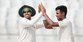  ??  ?? Bangladesh's Mustafizur Rahman, right, celebrates with his teammate Soumya Sarkar after the dismissal of Australia's David Warner during the third day of their second Test cricket match in Chittagong, Bangladesh, Wednesday. (AP)