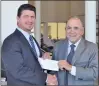  ?? Courtesy photo ?? L-r, Chuck Coia General Manager of Valencia BMW presents a check as season sponsor to Dr. Mark Elfont, President of the Santa Clarita Philharmon­ic Orchestra.