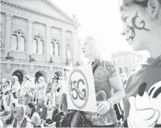  ?? — AFP photo ?? People take part in a nationwide protest against the 5G technology and 5Gcompatib­le antennae deployment in front of the Swiss house of Parliament in Bern.