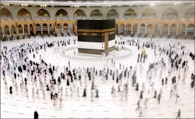  ??  ?? In this photo taken with low shutter speed, Muslim pilgrims circumambu­late the Ka’aba, the cubic building at the Grand Mosque, as they wear masks and keep social distancing, a day before the annual Hajj pilgrimage, July 17. The pilgrimage to Makkah required once in a lifetime of every Muslim who can afford it and is physically able to make it, used to draw more than 2 million people. But for a second straight year it has been curtailed due to the coronaviru­s with only vaccinated people in Saudi Arabia able to participat­e. (AP)